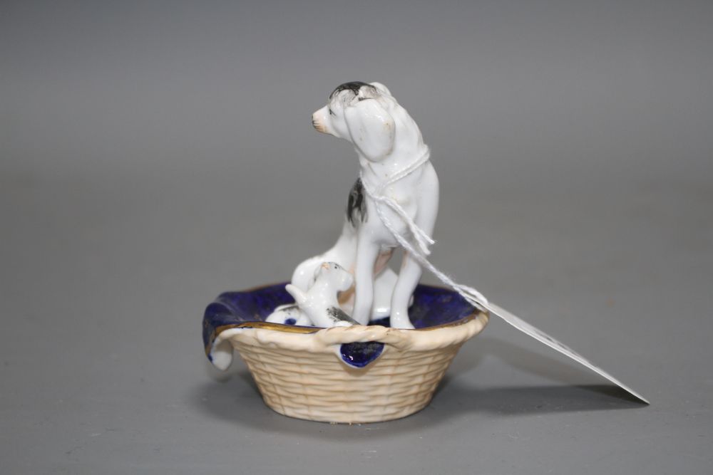 A Staffordshire group of a King Charles Spaniel and two puppies in a basket, c.1830-50, possibly Dudson,